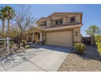 Inviting two-story home showcasing a spacious driveway and well-manicured landscaping at 26842 N 176Th Ln, Surprise, AZ 85387