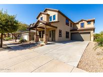Beautiful two-story home featuring a covered porch with stone accents and a spacious driveway at 3914 E Constance Way, Phoenix, AZ 85042