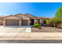 Charming single-story home showcasing a well-maintained front yard and an attached two-car garage at 41961 W Centennial Rd, Maricopa, AZ 85138