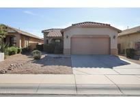 Charming single-story home featuring a well-maintained yard and two-car garage at 45071 W Yucca Ln, Maricopa, AZ 85139