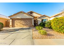 Inviting single-Gathering home with a well-manicured front yard and a two-car garage at 45564 W Sheridan Rd, Maricopa, AZ 85139