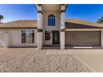 Charming home exterior with pillars, neutral color scheme, and a well-maintained front yard at 4940 E Grandview St, Mesa, AZ 85205