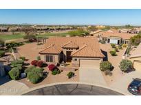 Attractive single-story home features well-maintained landscaping, a tile roof, and a two-car garage in a golf community at 5812 S Staghorn Cholla Ct, Gold Canyon, AZ 85118