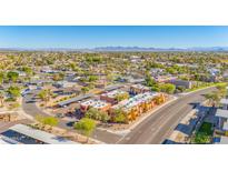 A lovely aerial view of the property and neighborhood, highlighting covered parking and mountain views in the distance at 604 E Weber Dr # 12, Tempe, AZ 85288