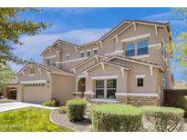 Inviting two-story home featuring a neutral color palette, well-maintained landscaping, and an attached two-car garage at 6204 S Banning St, Gilbert, AZ 85298