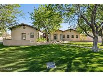 Well-maintained home exterior with a lush green lawn and mature trees at 8336 S Homestead Ln, Tempe, AZ 85284
