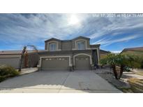 Charming two-story home with a spacious three-car garage and desert landscaping at 10423 E El Moro Ave, Mesa, AZ 85208