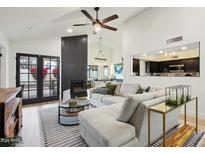 Bright living room featuring a modern fireplace, comfortable seating, and stylish decor at 11033 E Poinsettia Dr, Scottsdale, AZ 85259