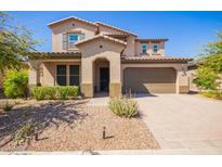 Charming two-story home featuring a well-manicured lawn and a welcoming front entrance at 13660 N 144Th Ln, Surprise, AZ 85379