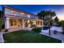 Beautiful backyard featuring a pool, covered patio, and lush landscaping, perfect for outdoor entertaining at 1614 E Kathleen Rd, Phoenix, AZ 85022