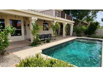 Inviting backyard pool with a covered patio area and lush greenery at 1614 E Kathleen Rd, Phoenix, AZ 85022