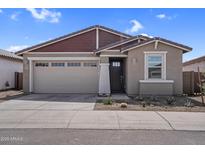 Charming single-story home featuring a two-car garage and low-maintenance desert landscaping at 17033 W Royal Palm Rd, Waddell, AZ 85355