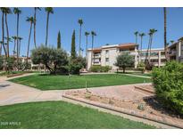 Beautifully landscaped community with lush green spaces and mature trees at 17404 N 99Th Ave # 214, Sun City, AZ 85373