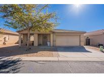 Charming single-story home with a welcoming front porch and a two-car garage at 2573 S Powell Rd, Apache Junction, AZ 85119