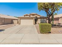 Charming single-story home featuring a two-car garage, desert landscaping, and a well-maintained front yard at 262 W Sheffield Ave, Gilbert, AZ 85233