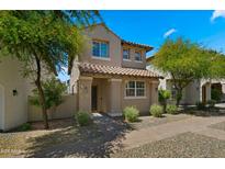 Charming two-story home with a tile roof, a covered porch and landscaped front yard at 29031 N 125Th Ln, Peoria, AZ 85383