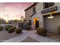Beautiful two-story home featuring stone accents, a well-manicured front yard, and inviting walkway at 470 N 168Th Ln, Goodyear, AZ 85338