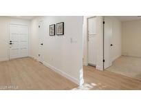 Bright hallway features light wood floors, white walls, and modern art at 4846 E Grandview St, Mesa, AZ 85205