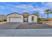 Beautiful single-story home featuring a well-manicured desert landscape and a brick-paved driveway at 5100 S Peach Willow Ln, Gilbert, AZ 85298