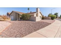 Warm-toned exterior with desert landscaping, a chimney, and a low-maintenance yard at 1537 W Impala Ave, Mesa, AZ 85202