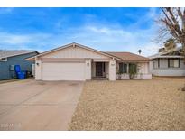 Charming single-story home featuring a low maintenance front yard and a two-car garage at 1627 E Saint Anne Ave, Phoenix, AZ 85042