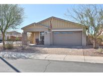 Charming single-story home featuring a two-car garage, desert landscaping, and a brick paver driveway at 20231 W Grant St, Buckeye, AZ 85326