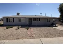 Charming single-story home with a well-maintained front yard and walkway leading to the entrance at 2801 W Camelback Rd, Phoenix, AZ 85017