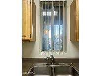 The kitchen features a stainless steel sink and faucet with a secured window at 2929 W Yorkshire Dr # 2121, Phoenix, AZ 85027