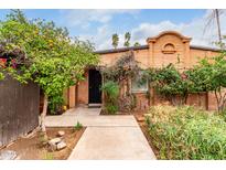 Charming brick home with a well-maintained yard, mature trees, and a welcoming front entrance with an arched entryway at 3046 N 32Nd St # 328, Phoenix, AZ 85018