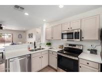 Bright kitchen featuring stainless steel appliances, modern cabinetry, and elegant quartz countertops at 43795 W Sagebrush Trl, Maricopa, AZ 85138