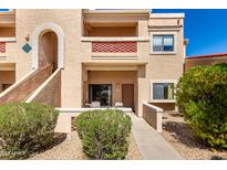 Tan condo building with balcony, small patio, and desert landscaping in front at 16354 E Palisades Blvd # 3103, Fountain Hills, AZ 85268