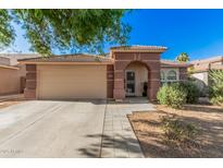 Charming single-story home featuring a stucco facade, a two car garage and desert landscaping at 17532 W Caribbean Ln, Surprise, AZ 85388