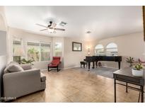 Inviting living room with neutral paint, tile floors, and many windows at 17532 W Caribbean Ln, Surprise, AZ 85388