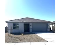 Charming single-story home featuring a gray color scheme, concrete driveway, and low maintenance landscaping at 18347 W Monte Lindo Ln, Surprise, AZ 85387