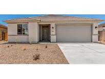Charming single-story home showcasing desert landscaping, a gray garage door, and a tiled roof at 18347 W Monte Lindo Ln, Surprise, AZ 85387