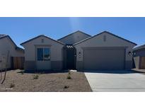 Charming single-story home with low-maintenance landscaping and a two-car garage at 18363 W Monte Lindo Ln, Surprise, AZ 85387