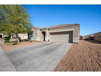 Charming single-story home featuring a neutral color scheme, well-maintained landscaping, and a two-car garage at 2038 N St Bonita Ct, Casa Grande, AZ 85122