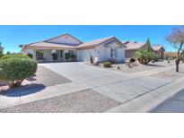 Charming single-story home featuring a well-manicured front yard, desert landscaping and a spacious driveway at 2369 E Fiesta Dr, Casa Grande, AZ 85194