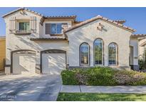 Inviting home exterior featuring a two-car garage, well-kept landscaping, and charming architectural details at 3816 E Phelps St, Gilbert, AZ 85295