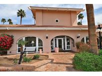 Welcoming clubhouse with tiled roof, desert landscaping, and palm trees at 4141 N 31St St # 404, Phoenix, AZ 85016