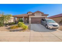 Charming single-story home with a well-manicured desert landscape, covered porch and two car garage at 5625 W Euclid Ave, Laveen, AZ 85339