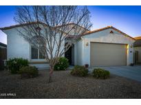 Charming single-story home featuring a well-maintained landscape and a two-car garage at 12030 W Louise Ct, Sun City, AZ 85373