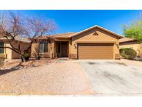 Charming single-story home featuring a two-car garage and a low-maintenance desert landscape at 12218 W Grant St, Avondale, AZ 85323