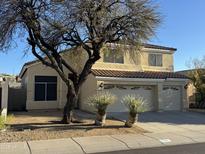 Inviting two-story home with a three-car garage, desert landscaping, and a red tile roof at 1526 E Charleston Ave, Phoenix, AZ 85022