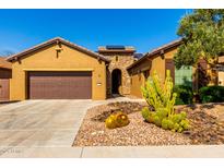 Inviting single-story home boasting desert landscaping, a two-car garage, and tasteful architectural details at 16390 W Sheila Ln, Goodyear, AZ 85395