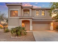 Two-story home featuring neutral stucco, tile roof, a well-kept yard, and two-car garage at 1701 W Wildwood Dr, Phoenix, AZ 85045