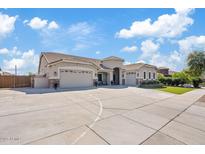 Expansive home with a circular driveway, three-car garage, and well-maintained landscaping at 21921 E Domingo Rd, Queen Creek, AZ 85142