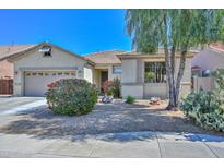 Charming single-story home featuring a well-maintained desert landscape and a two-car garage at 24215 N 59Th Ave, Glendale, AZ 85310