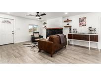 Inviting living room featuring a stone fireplace and wood-look tile flooring at 2512 N 29Th St, Phoenix, AZ 85008