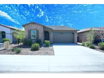 Charming single-story home with stone accents, well-maintained landscaping, and a two-car garage at 9413 W Devonshire Ave, Phoenix, AZ 85037